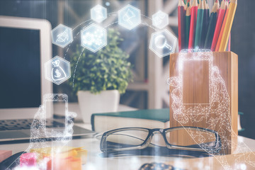 Tech theme hologram with glasses on the table background. Technology concept. Double exposure.