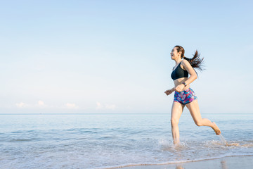 Middle-aged women who running by the sea. good health and happiness concept.