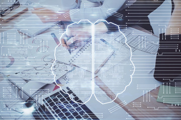 Double exposure of woman's writing hand on background with brain hud. Concept of learning.