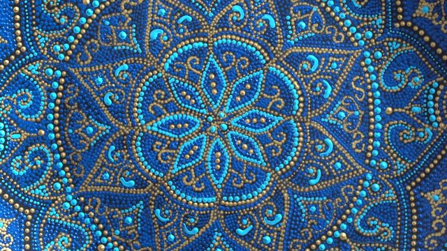 Decorative ceramic plate with blue and golden colors, painted plates, close up, rotates, handmade. Decorative porcelain plate painted with acrylic paints, handwork