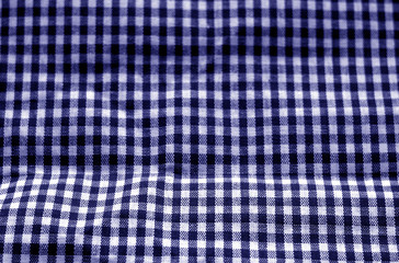 Checked fabric texture in blur effect in blue tone.