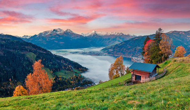 Fantastic morning scene of Zell lake. Great autumn sunrise view of Austrian town - Zell am See, south of the city of Salzburg. Beauty of nature concept background.