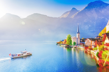 Colorful autumn seasonal scene of Hallstatter see lake in Austria and UNESCO historical village...
