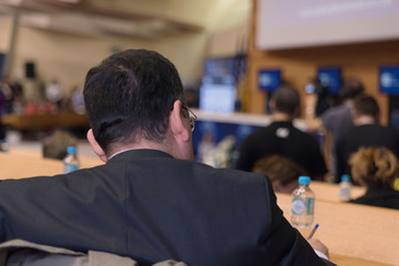 Businessman at business conference room with public giving presentations. Audience at the conference hall. Entrepreneurship club.