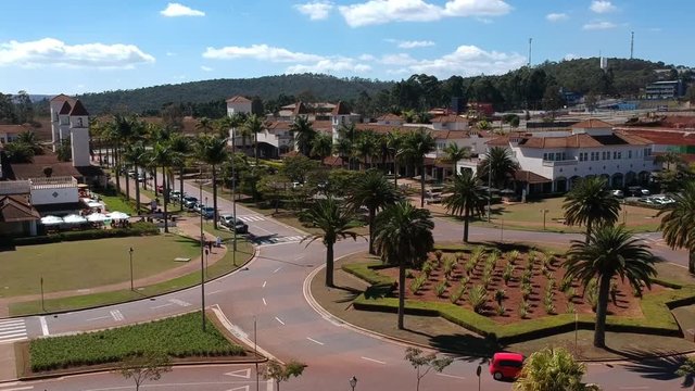 Aerial view of a condominium center. Real state. Red car driving the roundabout. Peacefull, smooth movement. Lagoa dos Ingleses.