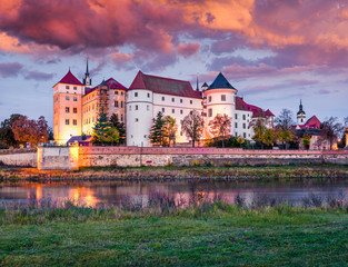 Naklejka na ściany i meble Impressive sunrise view of Hartenfels castle. Splendid morning view of Torgau town on the banks of the Elbe in northwestern Saxony, Germany. Traveling concept background.