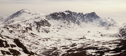 Hiking the snowy Arctic Circle Trail long distance hiking path in Greenland during winter.