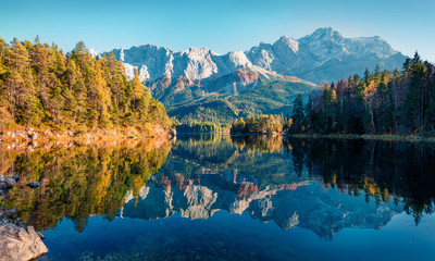 Bright evening scene of Eibsee lake with Zugspitze mountain range on background. Beautifel autumn view of Bavarian Alps, Germany, Europe. Beauty of nature concept background. - obrazy, fototapety, plakaty