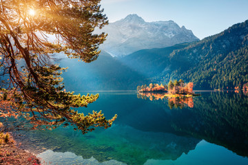 Sunny morning scene of Eibsee lake with Zugspitze mountain range on background. Beautifel autumn...