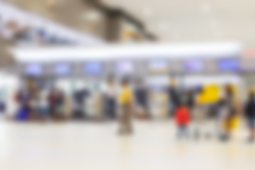Blurred of passengers walk in to check-in counter on domestic airline in the airport