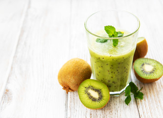 Glass of kiwi smoothie with fresh fruits
