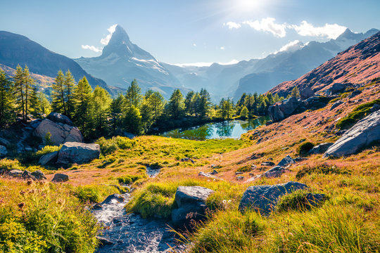 Sunny summer scene of Grindjisee lake. Beautiful morning view of Matterhorn (Monte Cervino, Mont Cervin) peak, Swiss Alps, Zermatt location, Switzerland. Beauty of nature concept background.