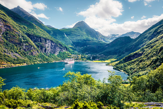 Splendid summer scene of Geiranger port, western Norway. Colorful view of Sunnylvsfjorden fjord. Traveling concept background. Artistic style post processed photo.