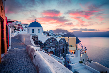 Dramatic morning view of Santorini island. Picturesque spring sunrise on the famous Greek resort Oia, Greece, Europe. Traveling concept background. Artistic style post processed photo. - obrazy, fototapety, plakaty