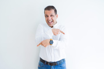 Middle age business man smiling and pointing to the side over white background