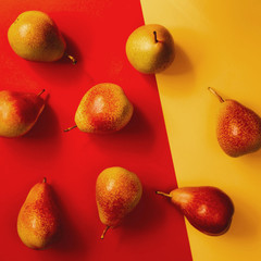 Yellow-red pears on a colored background. Vitamins, organic products, autumn harvest, vegetarianism, energy and juicy. Postcard for decor, flat lay, vibrance fine art.