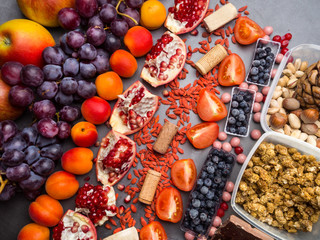 Healthy food clean eating selection: fruits,, superfood, nuts on gray concrete background