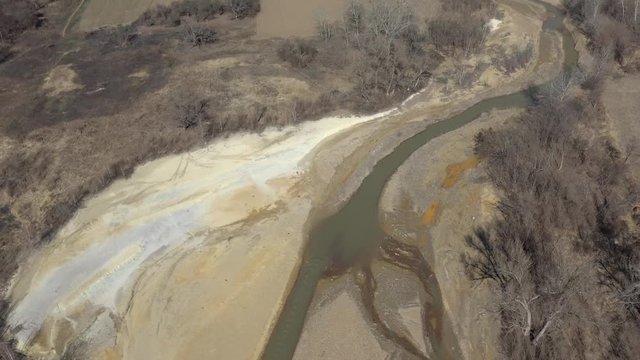Pyrite on river coast from mine drainage 4K aerial video