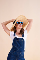 Joyful woman with sunglasses and sun hat