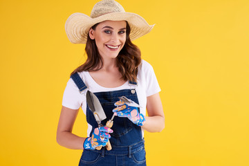 Portrait of gardener with gardening equipment in the studio shot