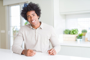 African American man at home winking looking at the camera with sexy expression, cheerful and happy...