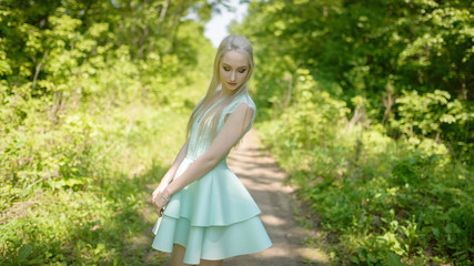 Fototapeta na wymiar Summertime portrait of young woman in dress.