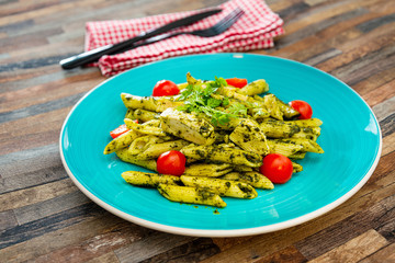 close-up of plate of pasta and chicken with lettuce