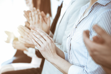 Business people clapping and applause at meeting or conference, close-up of hands. Group of unknown...
