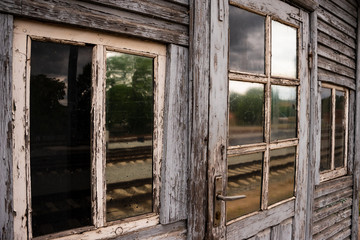 Facade of a very old beautiful wooden house near the railroad