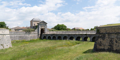 Fototapeta na wymiar Saint-Martin-de-Re, ile de Re France porte des Campani ditch and fortifications of entrance in Old Town