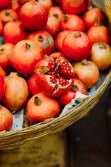 a basket full of pomegranates standing on Goa market