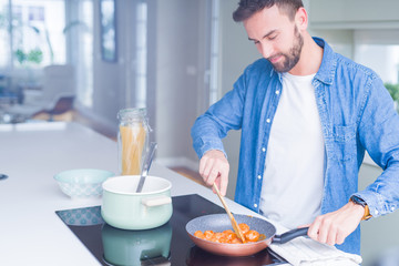 Handsome man cooking pasta at home