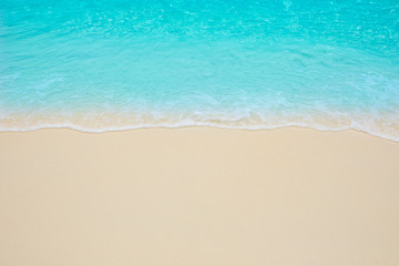 Fototapeta na wymiar Soft waves of blue sea on the Maldives beach for the background.