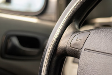 Obraz na płótnie Canvas driving wheel with horn sign, car interior