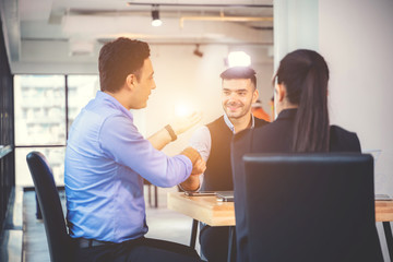 Businesspeople discussing together in conference room during meeting at office.