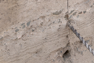 People are using electric drill,He drilled concrete to put steel anchor.