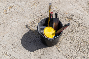 Image of construction tools in a bucket
