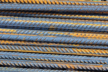 A large number of fittings. Rusty iron rods for construction. Strengthening of concrete structures. Texture, background