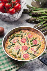 Frittata made of eggs, asparagus and tomatoes