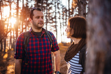 Hiking couple talking in the forest