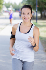 sporty female jogger running and training outside in nature