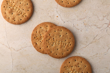 Stack of sweetmeal digestive biscuits closeup of a pile of biscuits on a texture background