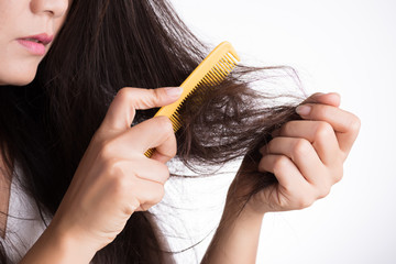 Healthy concept. Woman show her brush with damaged long loss hair and looking at her hair.