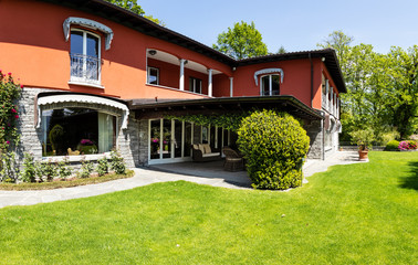 Exterior of luxury villa with green garden and nature