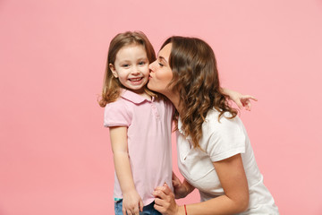 Woman in light clothes have fun with cute child baby girl. Mother, little kid daughter isolated on...