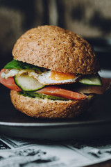 Salmon and Quail Egg Sandwich on a dark rustic background, selective focus