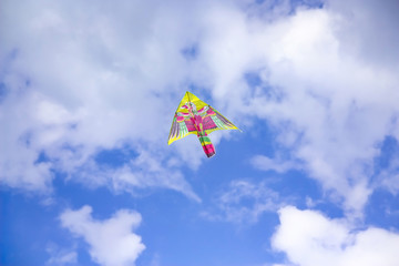 colorful Kite flying in the sky among the clouds