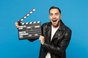 Handsome stylish young unshaven man in black jacket white t-shirt hold in hand film making...