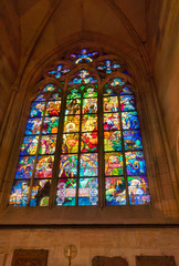 Prague, Czech Republic-February 01, 2019. Stained glass window with scenes of early christianity in Bohemia was installed in the north nave in 1931 of St. Vitus Cathedral.