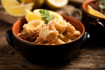 Traditional Italian fried calamari and lemon slice